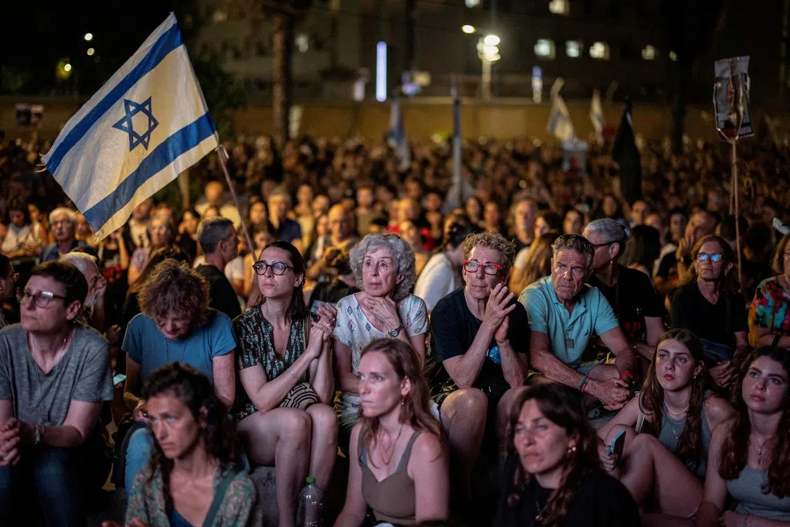FILE PHOTO: People attend a rally in support of hostages in Gaza, asking for their release, amid the ongoing Israel-Hamas conflict, in Tel Aviv, Israel, June 8, 2024. REUTERS/Marko Djurica/File Photo