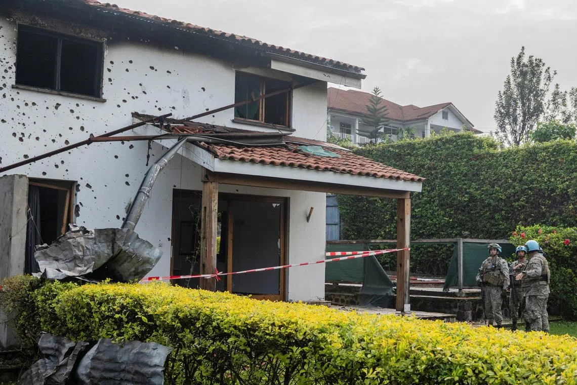 United Nations Organization Stabilization Mission in the Democratic Republic of the Congo (MONUSCO) peacekeepers assess after Congolese firefighters extinguished a fire caused by a drone strike that hit a residential neighborhood in Goma, occupied by M23 rebels, in North Kivu province, Democratic Republic of Congo, March 11, 2026. REUTERS/Stringer