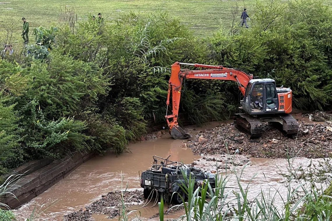 This picture taken and released by the Vietnam News Agency (VNA) on October 24, 2023 shows the wreckage of a jeep (bottom), which was swept away during its crossing of a stream while carrying four South Korean tourists who were later found dead, in Vietnam's Da Lat resort city in Lam Dong province. The accident happened midday as the stream water near the Cu Lan tourism site in Lac Duong district "suddenly rose high" following three days of continous rains in central highlands Lam Dong province. (Photo by Vietnam News Agency / AFP)
