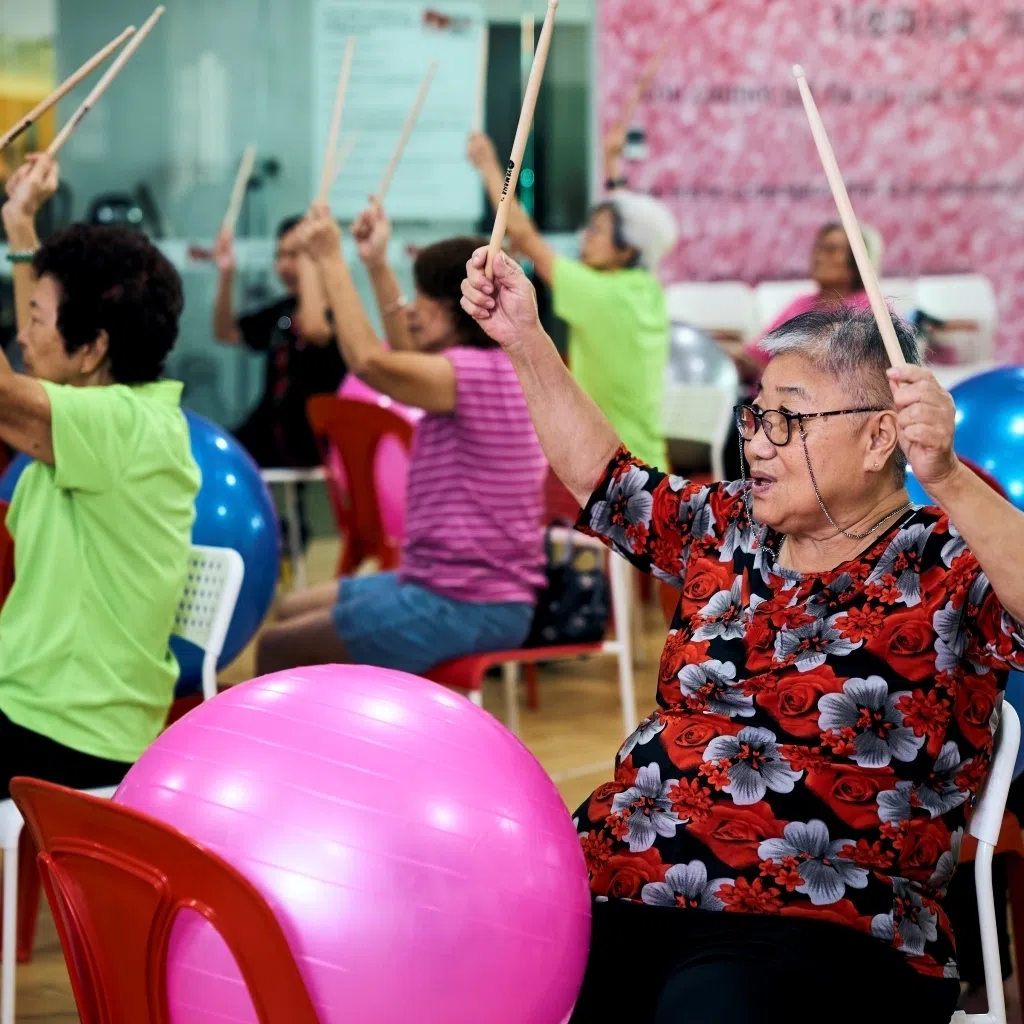 Retiree Quek Lee Hai (pictured in red) takes part in weekly exercise ball drumming sessions held at the Adventist Active Ageing Centre near her home to stay active. 