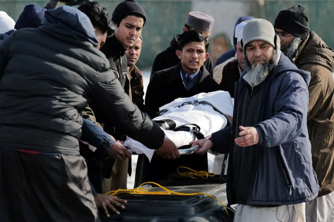 FILE PHOTO: Community members and loved ones carry the body of Nurul Amin Shah Alam, a nearly blind refugee from Myanmar who was missing since his release from a jail into the custody of the U.S. Border Patrol, and who was later found dead, during his funeral service, in Buffalo, New York, U.S., February 26, 2026. REUTERS/Craig Ruttle/File Photo