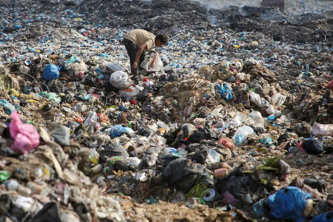 A Palestinian scavenges for usable items at a dump site, amid the Israel-Hamas conflict, in Khan Younis in the southern Gaza Strip, July 15, 2024.REUTERS/Hatem Khaled