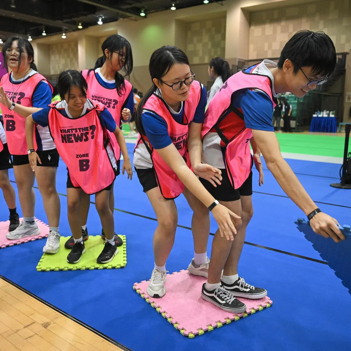 Yishun Innova Junior College students taking part in a game at the semi-finals of ST Whats the News! quiz competition at Our Tampines Hub on May 21, 2025.