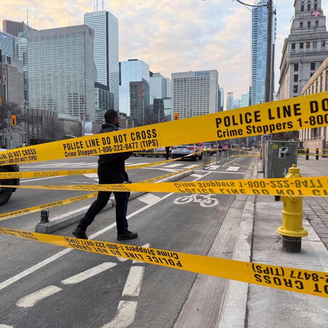 A member of law enforcement personnel works at the scene outside the U.S. Consulate after shots were fired, in Toronto, Ontario, Canada, March 10, 2026. Picture taken with a mobile phone. REUTERS/Kyaw Soe Oo