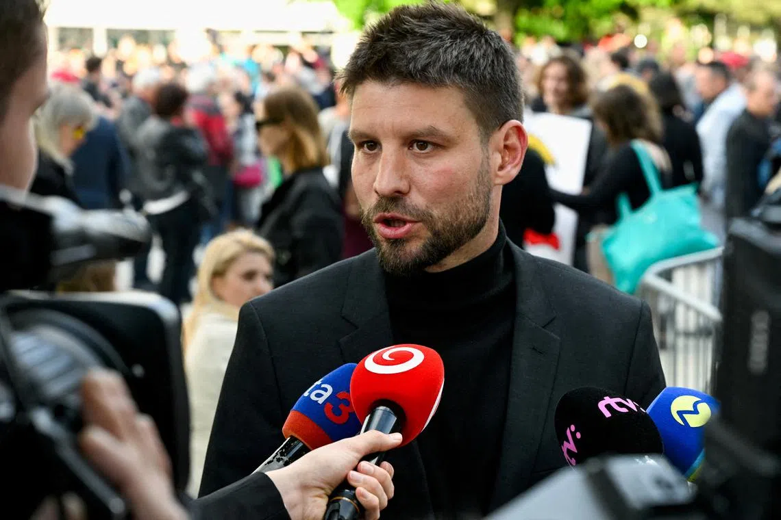 FILE PHOTO: Progressive Slovakia party leader Michal Simecka speaks to the media as demonstrators take part in a protest against government changes at public broadcaster RTVS in Bratislava, Slovakia, May 2, 2024. REUTERS/Radovan Stoklasa/File Photo