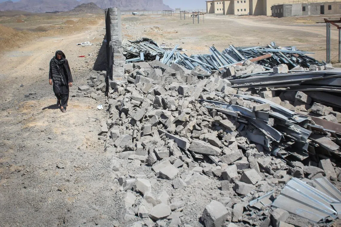 FILE PHOTO: An Afghan man walks past a damaged wall following airstrikes, amid the conflict between Afghanistan and Pakistan, in Kandahar, Afghanistan, February 28, 2026. REUTERS/Stringer/ File Photo