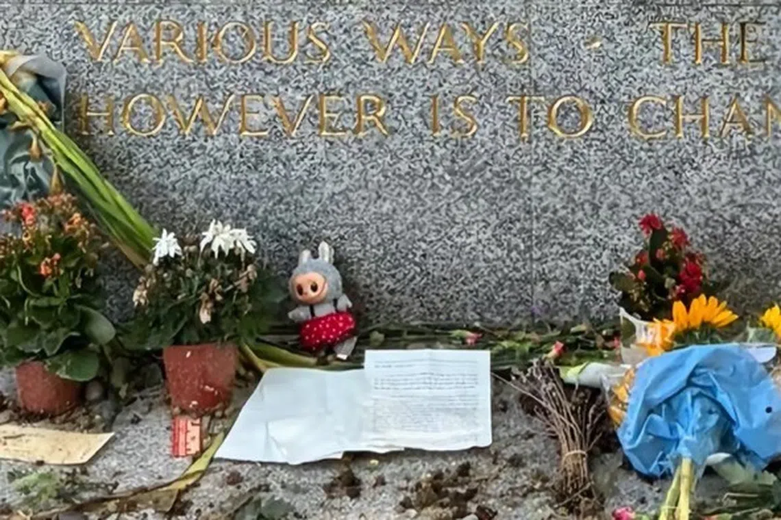 The popular elf-like plush toy, with its pointy ears and toothy grin, is seen among letters and flowers left on Marx's grave.
