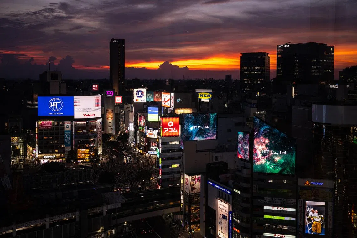 A general view shows the Shibuya district during sunset in Tokyo on August 28, 2023. (Photo by Philip FONG / AFP)