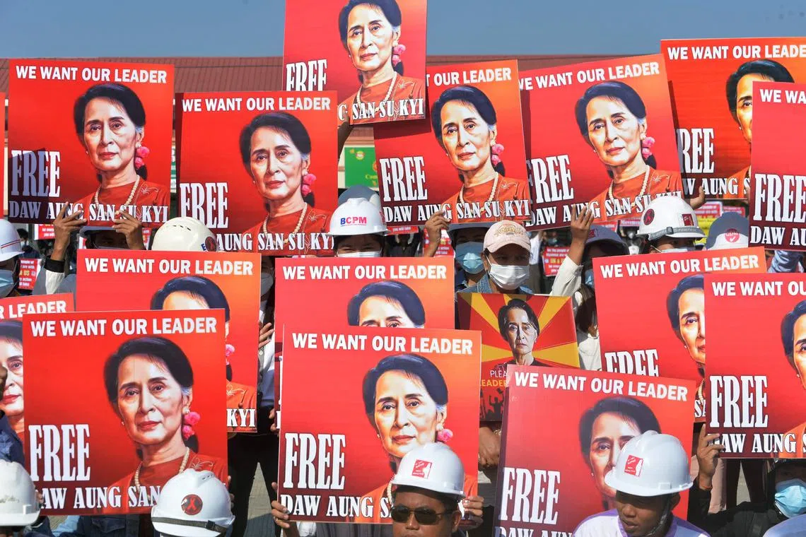 Protesters hold up signs calling for the release of detained Myanmar leader Aung San Suu Kyi during a demonstration in Naypyidaw on Feb 15, 2021.