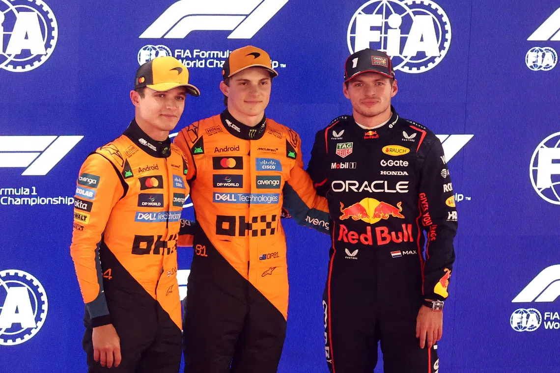 Formula One F1 - Qatar Grand Prix - Lusail International Circuit, Lusail, Qatar - November 29, 2025 McLaren's Oscar Piastri celebrates after qualifying in pole position with second placed McLaren's Lando Norris and third placed Red Bull's Max Verstappen REUTERS/Jakub Porzycki