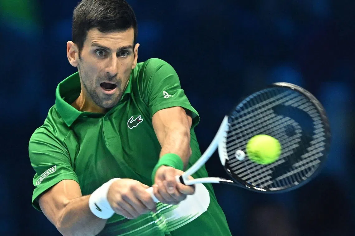 Novak Djokovic hitting a return to Taylor Fritz during their ATP Finals last-four clash on Nov 19, 2022.