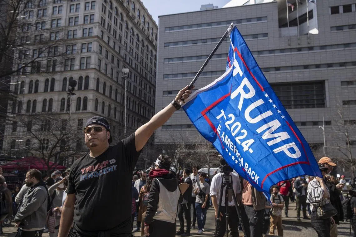A supporter of former US President Donald Trump outside criminal court in New York, US, on Tuesday, April 4.