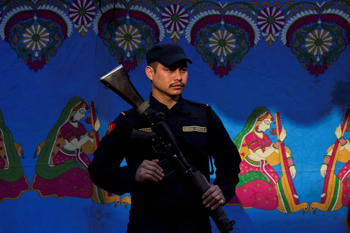 A member of Nepal police guarding a polling station in Patan Durbar Square during the general election in Lalitpur, Nepal, on March 5, 2026. 