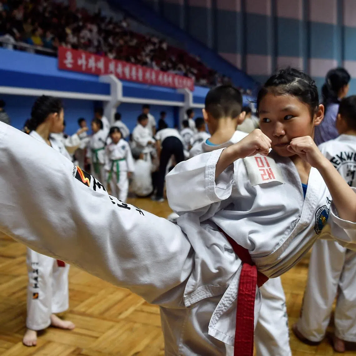 An aspiring athlete practices a kick during the National Taekwon-Do Fans Contest in Pyongyang on Aug 12.