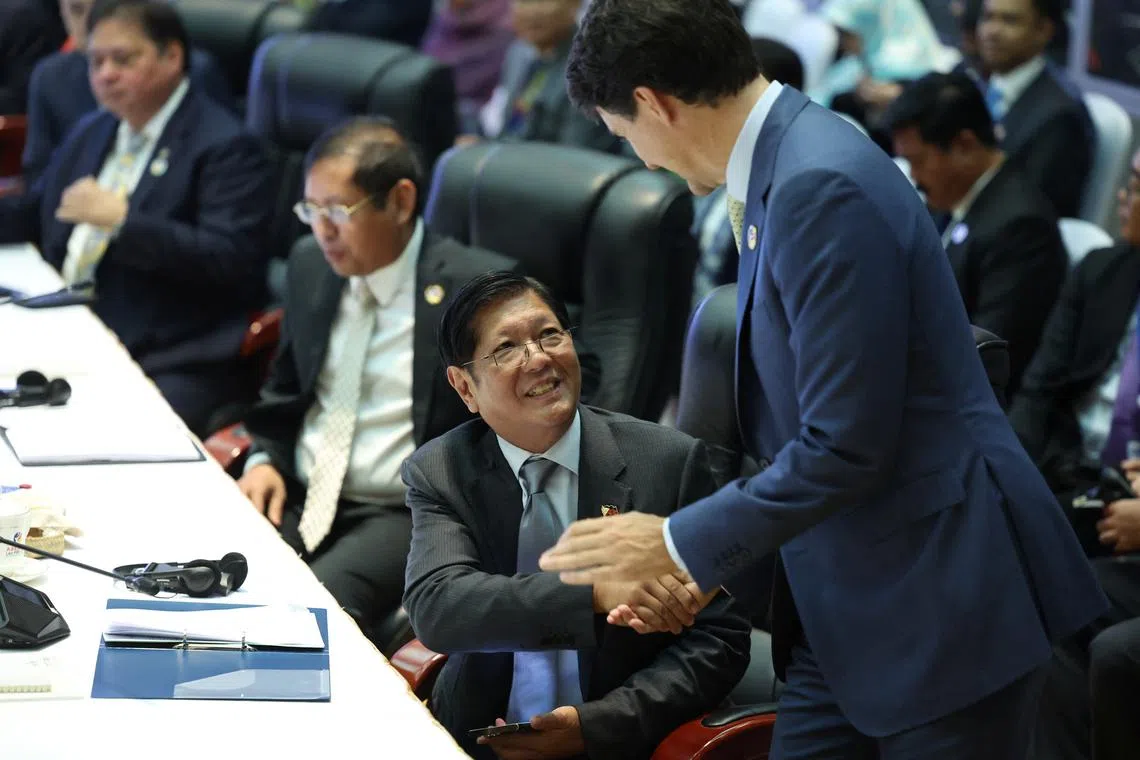 FILE PHOTO: Canada's Prime Minister Justin Trudeau shakes hands with Philippines President Ferdinand Marcos Jr during the ASEAN-Canada Special Summit on Enhancing ASEAN Connectivity and Resilience at the National Convention Centre, in Vientiane, Laos, October 10, 2024. REUTERS/Athit Perawongmetha/File Photo