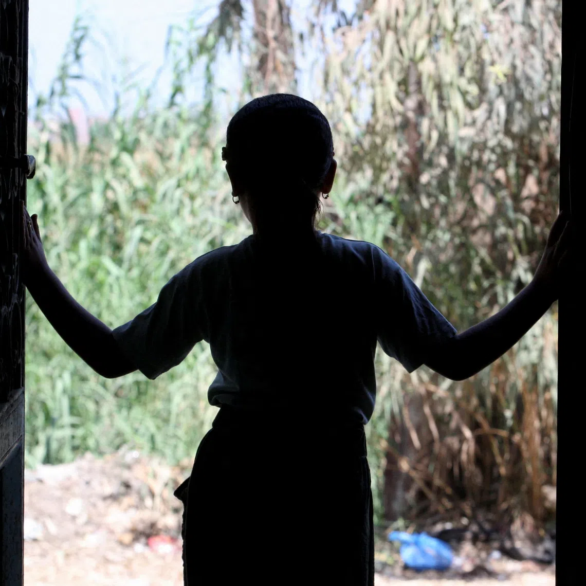 The daughter of Egyptian rape survivor Amal Abdel Hameed, who won a landmark paternity case, looks outside from her family home in Dakahlia Governorate, in the northeast of Egypt's Nile Delta, August 17, 2026. REUTERS/Stringer