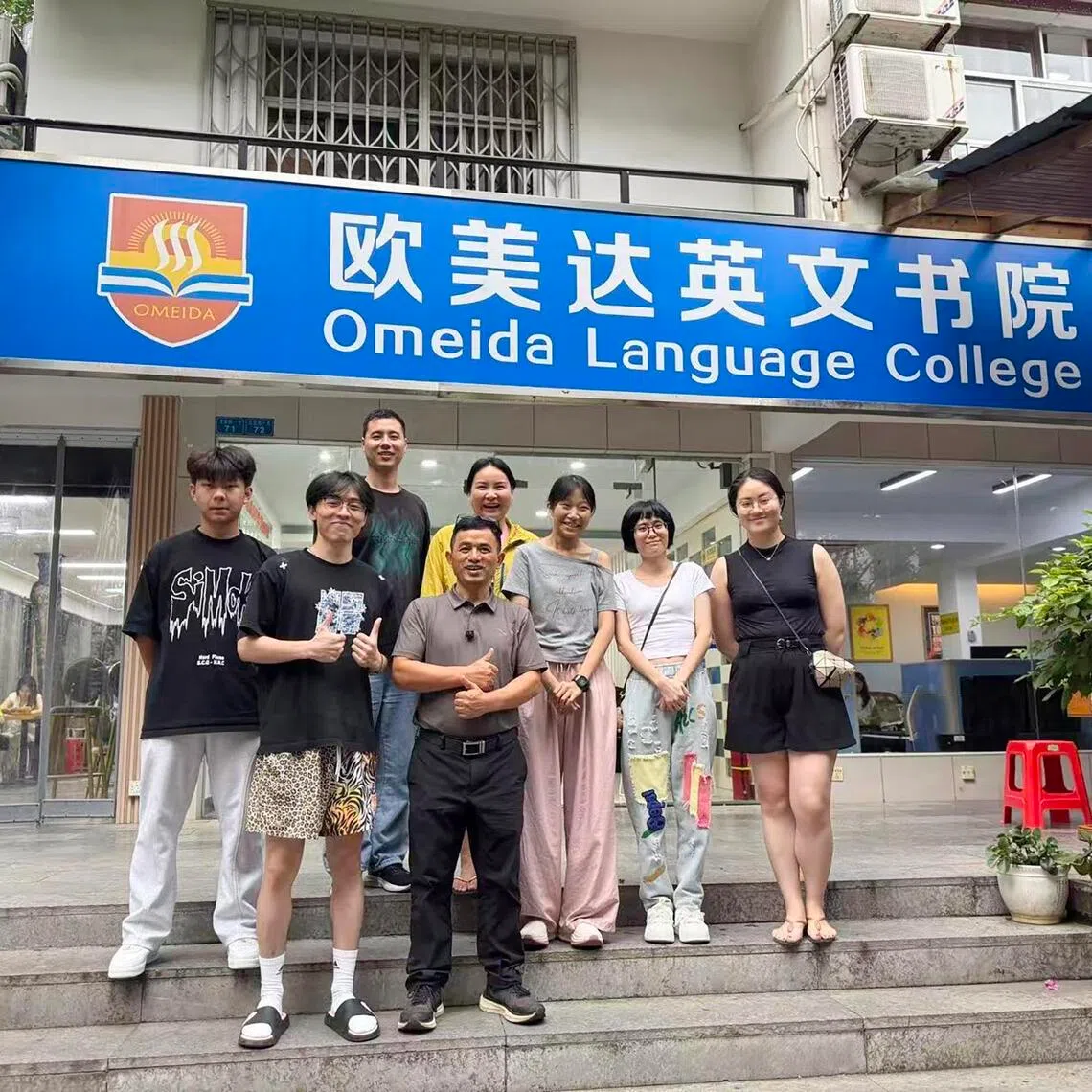 Ou Da (front row in black trousers), founder of Omeida Language College, poses with Chinese students learning English at the school’s Yangshuo campus in Guangxi Province.