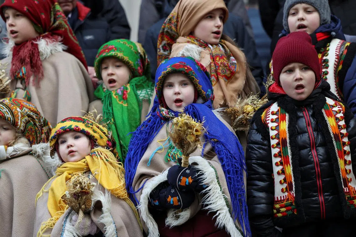 Children dressed in Ukrainian traditional costumes attend a Christmas celebration, in Lviv, Ukraine, on Dec 24.