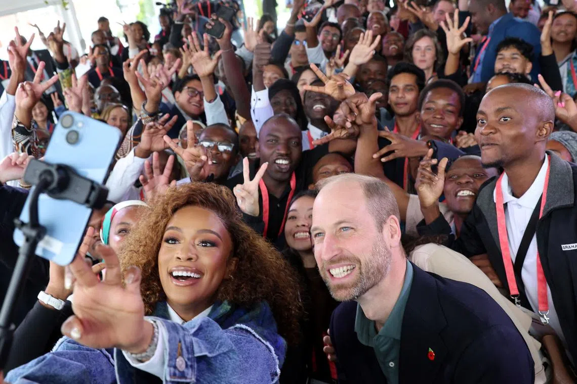 CAPE TOWN, SOUTH AFRICA - NOVEMBER 04: Prince William, Prince of Wales and Nomzamo Mbatha pose for a selfie with young people during the Earthshot Prize Climate Leaders Youth Programme on November 04, 2024 in Cape Town, South Africa. Chris Jackson/Pool via REUTERS