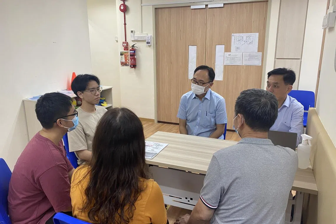 Bukit Panjang MP Liang Eng Hwa (centre) speaking to residents at his MPS on July 31. 