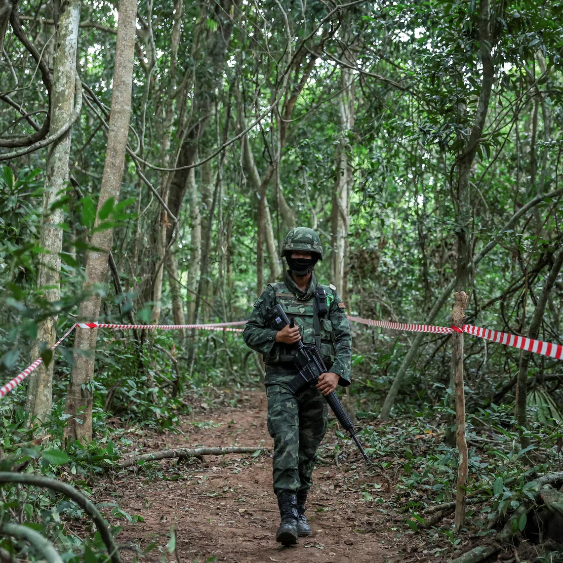 FILE PHOTO: Person from Thai military walks near Thai-Cambodian border at Chong Chub Ta Mok area, where landmines were found deployed, following a ceasefire between Cambodia and Thailand, in Surin Province, Thailand, August 20, 2025. REUTERS/Chalinee Thirasupa/File Photo