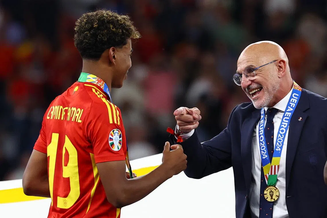 Soccer Football - Euro 2024 - Final - Spain v England - Berlin Olympiastadion, Berlin, Germany - July 14, 2024 Spain's Lamine Yamal celebrates with coach Luis de la Fuente after winning the Euro 2024 REUTERS/Lee Smith