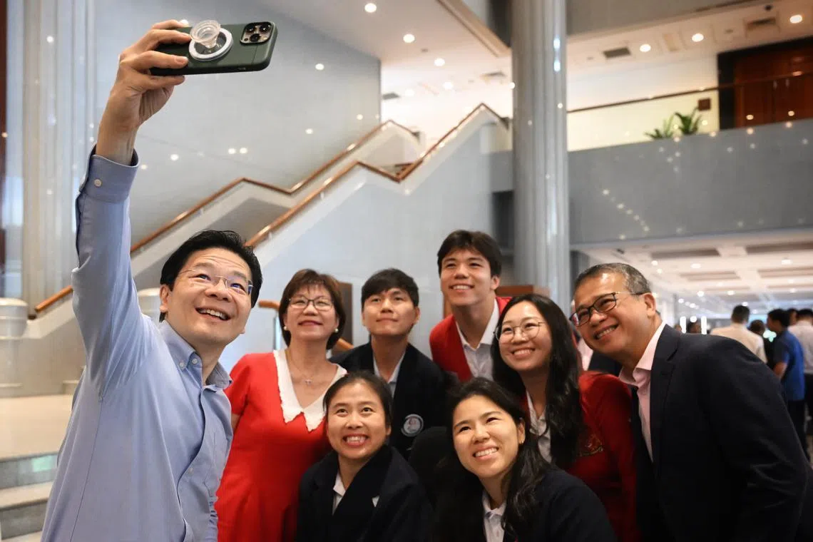 Clockwise from PM Wong: PM Lawrence Wong takes a wefie with MP Denise Phua, para-shooter Daniel Chan, 2024 Olympic bronze medallist (sailing)Maximilian Maeder; national shooter Teh Xiu Hong, MCCY Minister Edwin Tong, Paralympic gold medalist (swimming)Yip Pin Xiu and Paralympic silver medalist (boccia) Jeralyn Tan, on Oct 16, 2024.

(Clockwise from left) PM Lawrence Wong takes a wefie with MP Denise Phua, para-shooter Daniel Chan, Olympic bronze medallist Maximilian Maeder