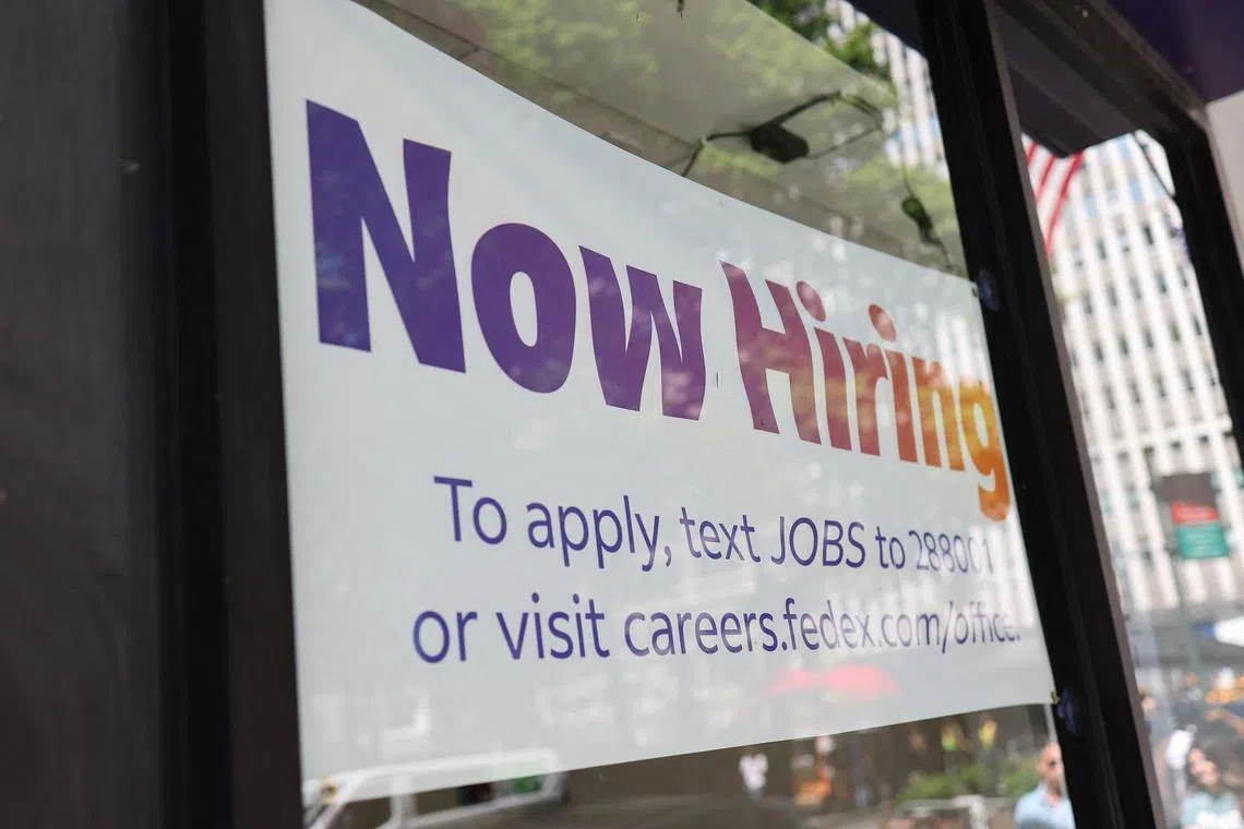 (FILES) A "Now Hiring" sign is seen at a FedEx location on E 42nd Street on June 7, 2024 in New York City. The US added 206,000 jobs in June, said the Labor Department on July 5, 2024,, marking a slower pace of hiring than May's revised 218,000 figure. The jobless rate ticked up from 4.0 percent to 4.1 percent. (Photo by Michael M. Santiago / GETTY IMAGES NORTH AMERICA / AFP)