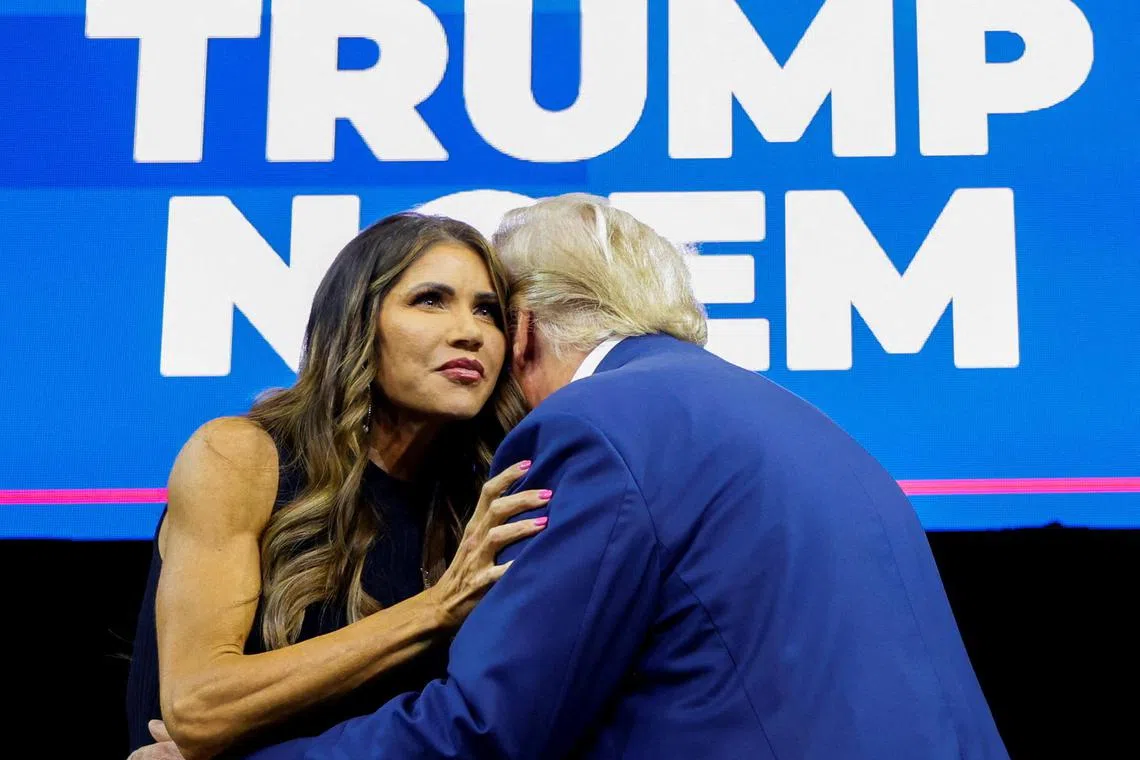 South Dakota Governor Kristi Noem greets former US President and Republican presidential candidate Donald Trump before he speaks at a South Dakota Republican party rally in South Dakota in 2023.