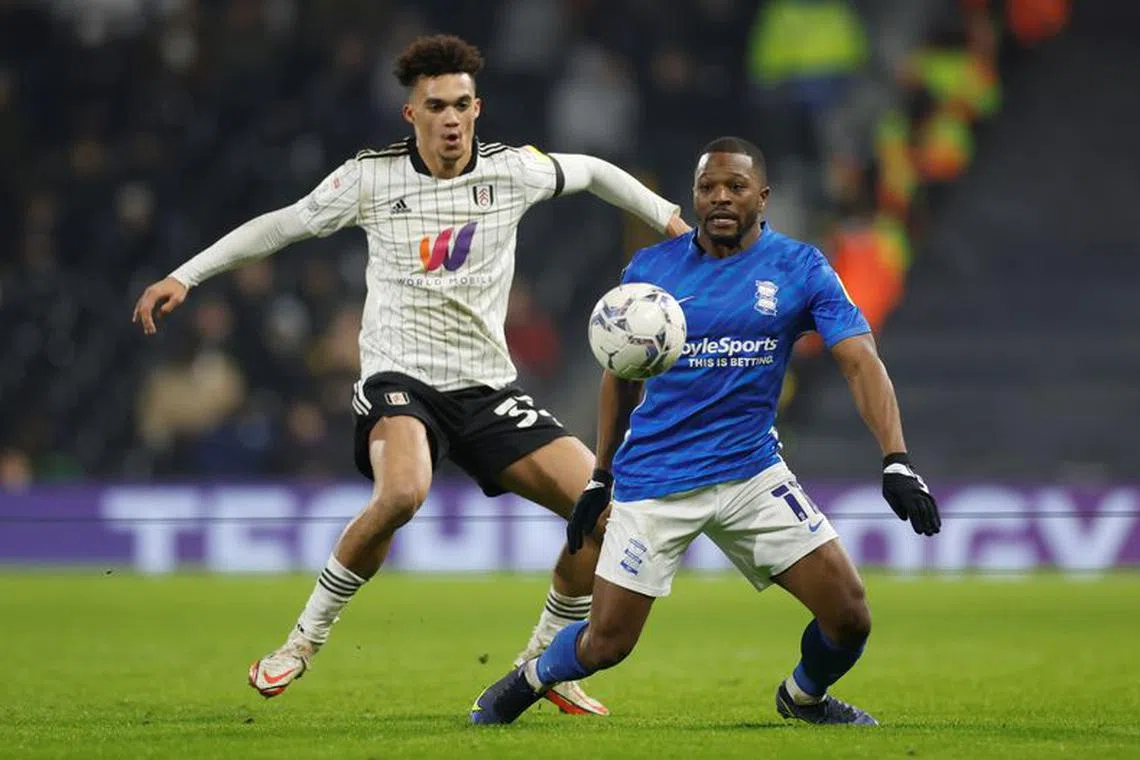 Soccer Football - Championship - Fulham v Birmingham City - Craven Cottage, London, Britain - January 18, 2022 Fulham?s Antonee Robinson in action with Birmingham City?s Jeremie Bela  Peter Cziborra/Action Images/File photo