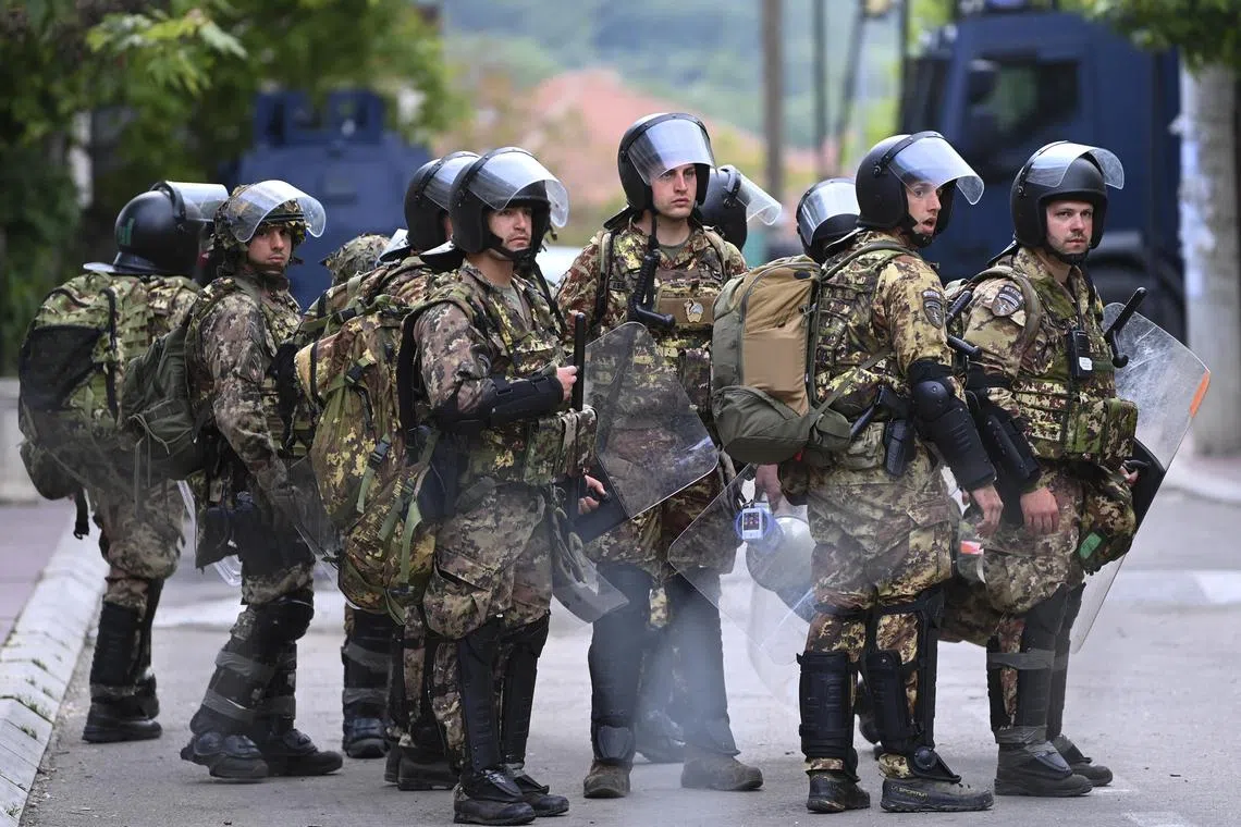 Nato-led international peacekeeping soldiers stand guard in Zvecan, Kosovo.