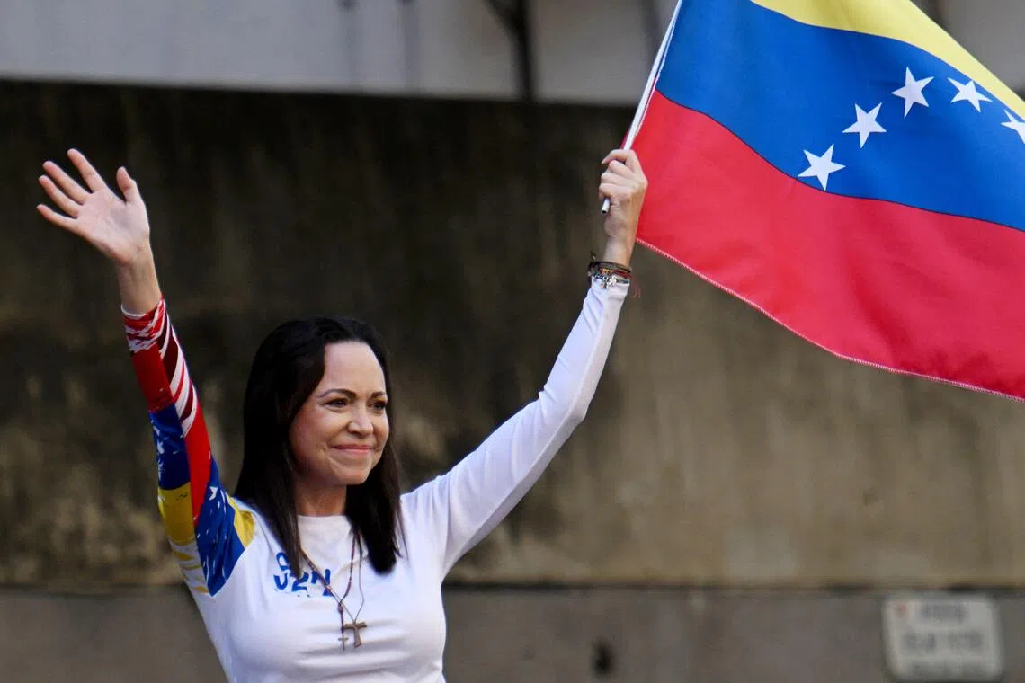 Venezuelan opposition leader Maria Corina Machado waves a national flag during a protest called by the opposition on the eve of the presidential inauguration, in Caracas on Jan 9, 2025. 