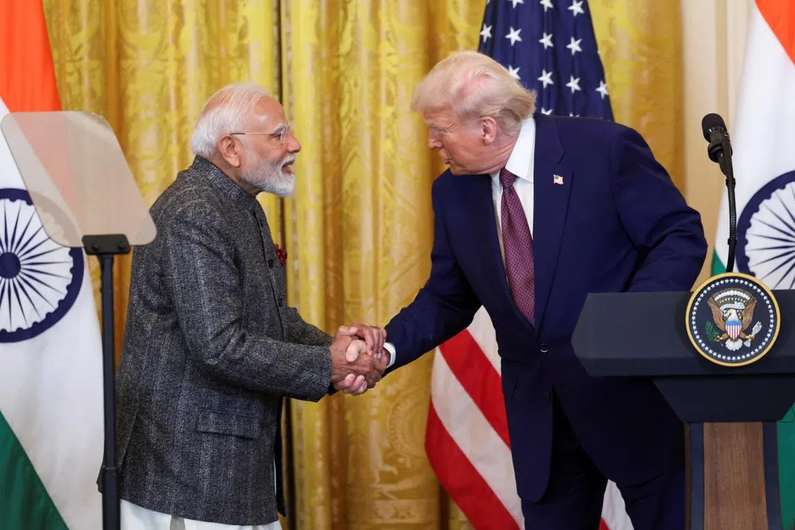 FILE PHOTO: U.S. President Donald Trump and Indian Prime Minister Narendra Modi shake hands as they attend a joint press conference at the White House in Washington, D.C., U.S., February 13, 2025. REUTERS/Kevin Lamarque/File Photo
