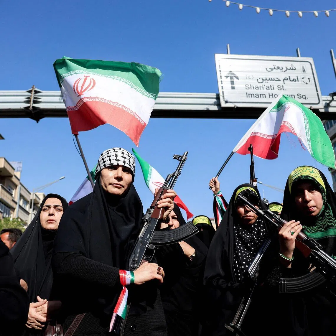 Iranian women brandish their rifles as they take part in a rally paying tribute to women killed during Iran’s war with the US and Israel.
