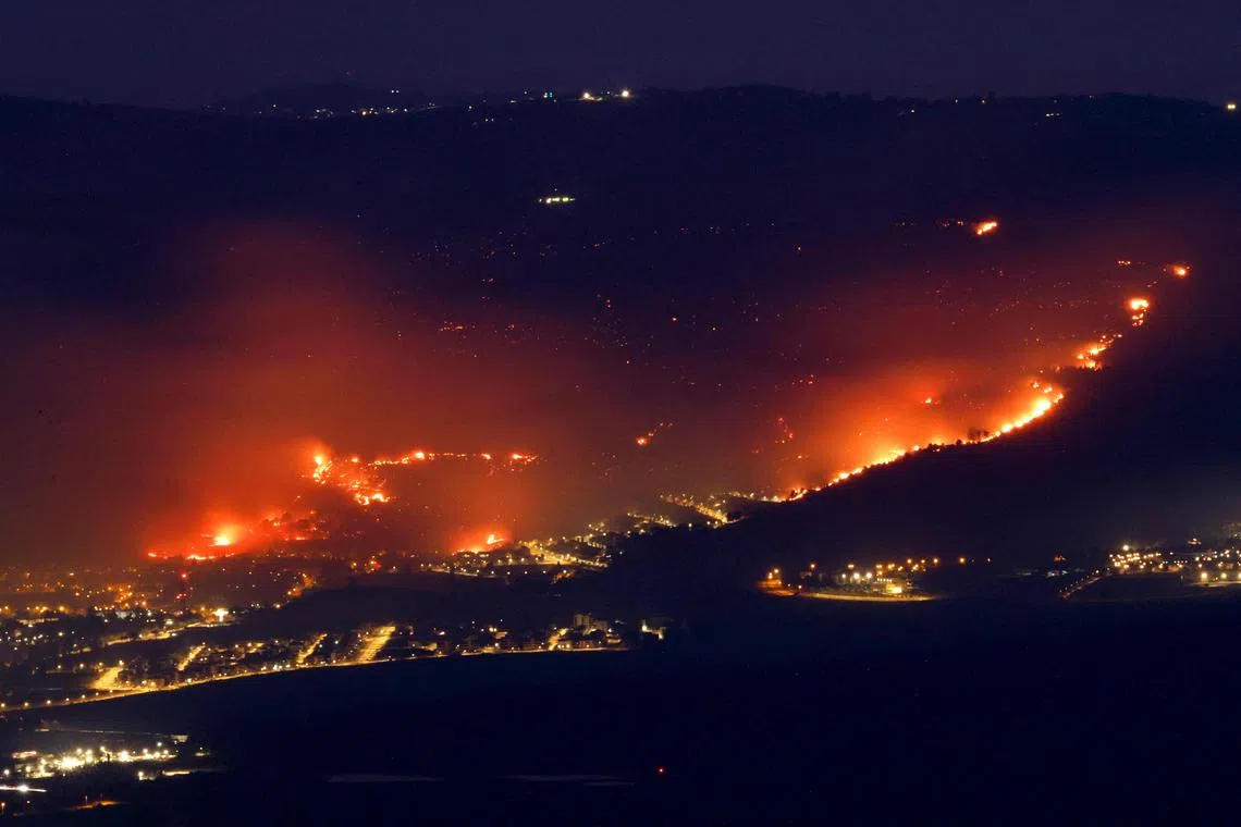 Fires burn on June 3 as a result of rockets launched from Lebanon into northern Israel, next to the city of Kiryat Shmona near the Lebanon border. 