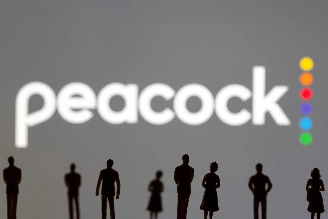 FILE PHOTO: Toy figures of people are seen in front of the displayed Peacock logo, in this illustration taken January 20, 2022. REUTERS/Dado Ruvic/Illustration/File Photo