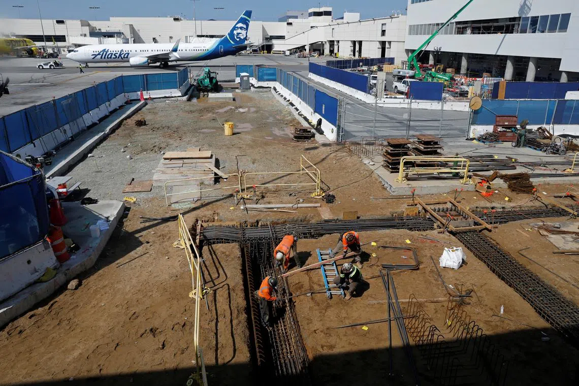 FILE PHOTO: Workers prepare a cabling trench at a construction site at Los Angeles International Airport (LAX) in Los Angeles, California, U.S., March 30, 2022. Picture taken March 30, 2022.  REUTERS/Chris Helgren/File Photo