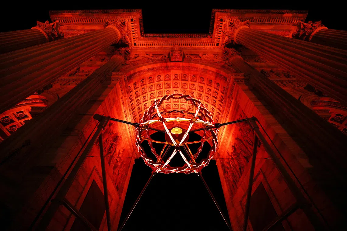 FILE PHOTO: Milano Cortina 2026 Olympics - Opening Ceremony - Arco della Pace, Milan, Italy - February 06, 2026. The Olympic flame is seen lit in the cauldron during the opening ceremony REUTERS/Guglielmo Mangiapane/File Photo