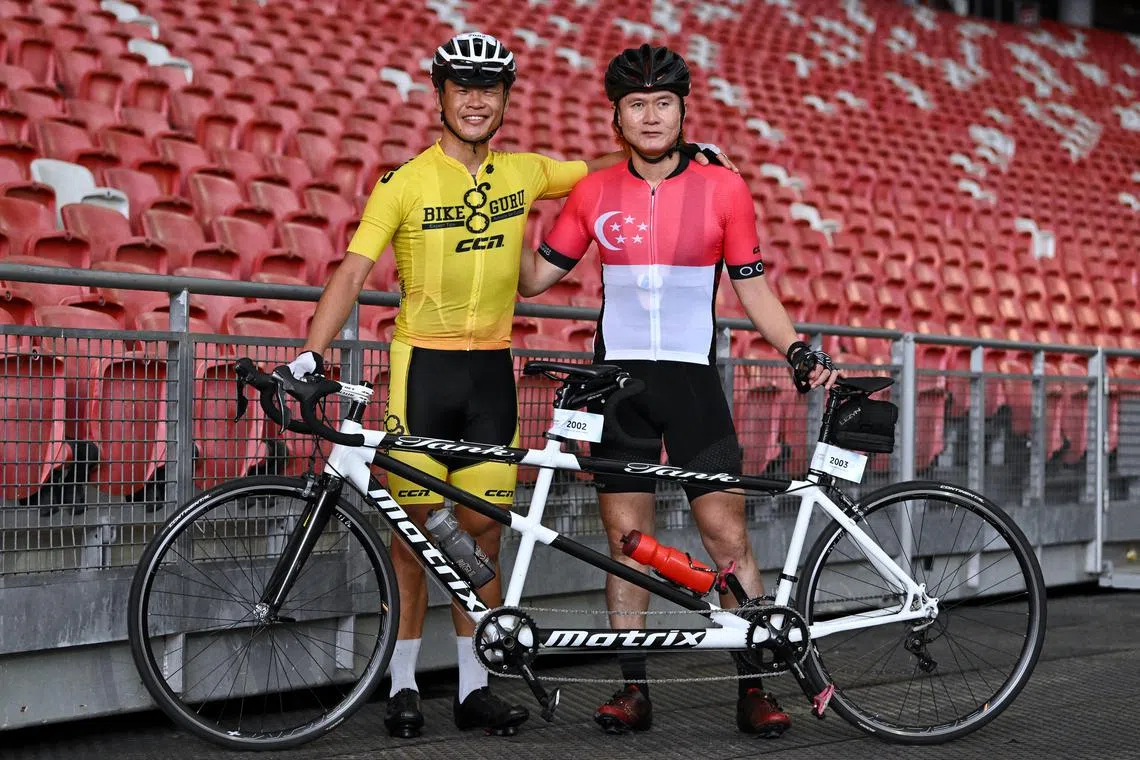 Terence Lee (left), 33 and Steve Tee, 42 at OCBC Cycle 2023. Lee helps to guide Steve, who is a paralympian, on a tandem bike.