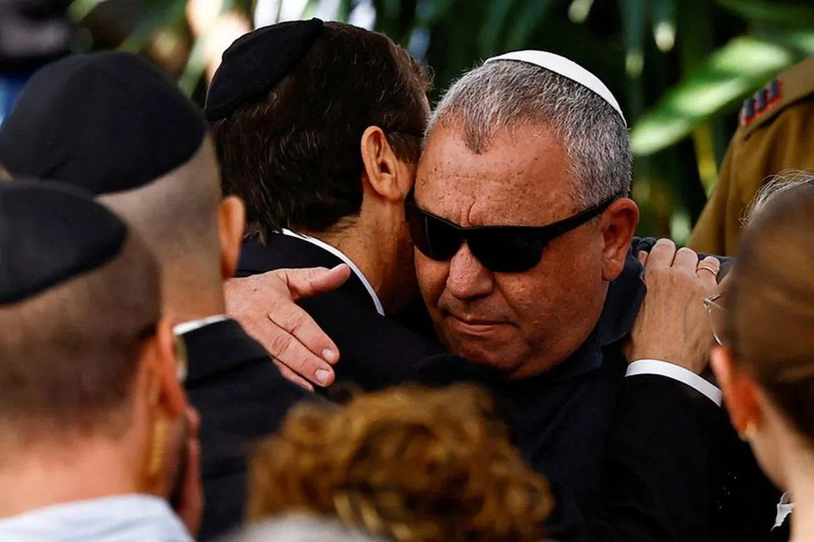FILE PHOTO: Israeli cabinet minister and former military chief Gadi Eizenkot is consoled by Israeli President Isaac Herzog, as he attends the funeral of his son Gal Meir Eisenkot, 25, an Israeli solider, who was killed in northern Gaza during the ongoing ground operation by Israel's military in the Gaza Strip, in Herzliya, Israel, December 8, 2023. REUTERS/Clodagh Kilcoyne/File Photo