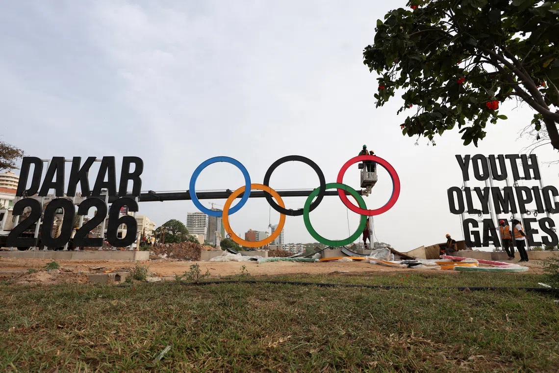 Workers assemble the Olympic rings as Senegal prepares to host the Youth Olympic Games, the first Olympic event to be held in Africa, in Dakar, Senegal, October 25, 2026. REUTERS/Misper Apawu