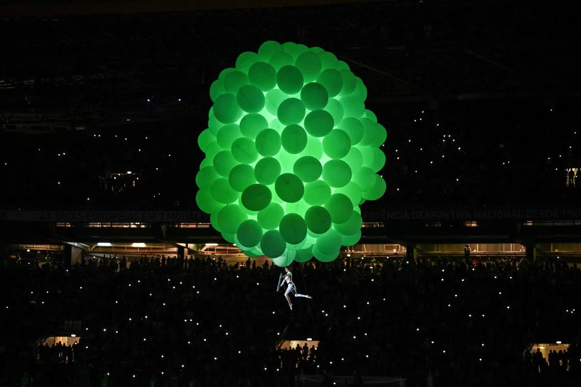 A performer suspending from balloons during Sporting's celebrations for winning the 2023-24 Portuguese League Championship following the Portuguese League football match between Sporting CP and GD Chaves at the Jose Alvalade stadium in Lisbon on May 18, 2024. 