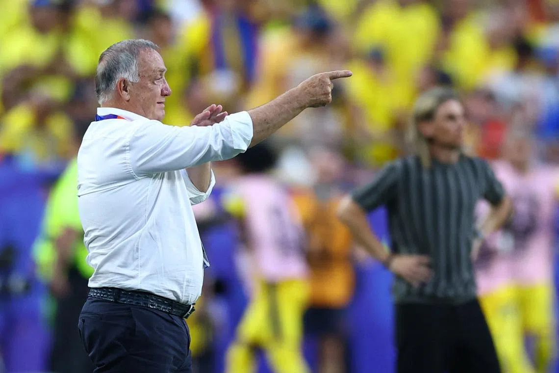 Curacao coach Dick Advocaat reacts as Ecuador coach Sebastian Beccacece looks on on June 20.