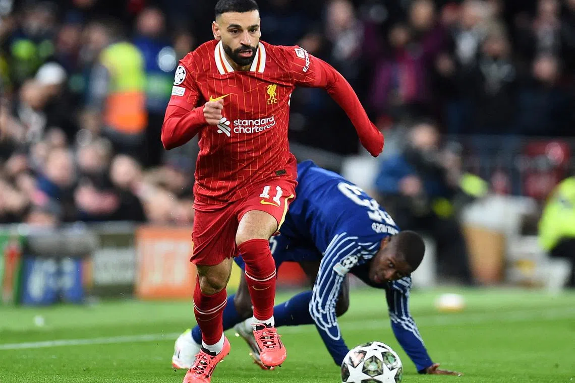 FILE PHOTO: Soccer Football - Champions League - Round of 16 - Second Leg - Liverpool v Paris St Germain - Anfield, Liverpool, Britain - March 11, 2025 Liverpool's Mohamed Salah in action with Paris St Germain's Nuno Mendes REUTERS/Peter Powell/File Photo