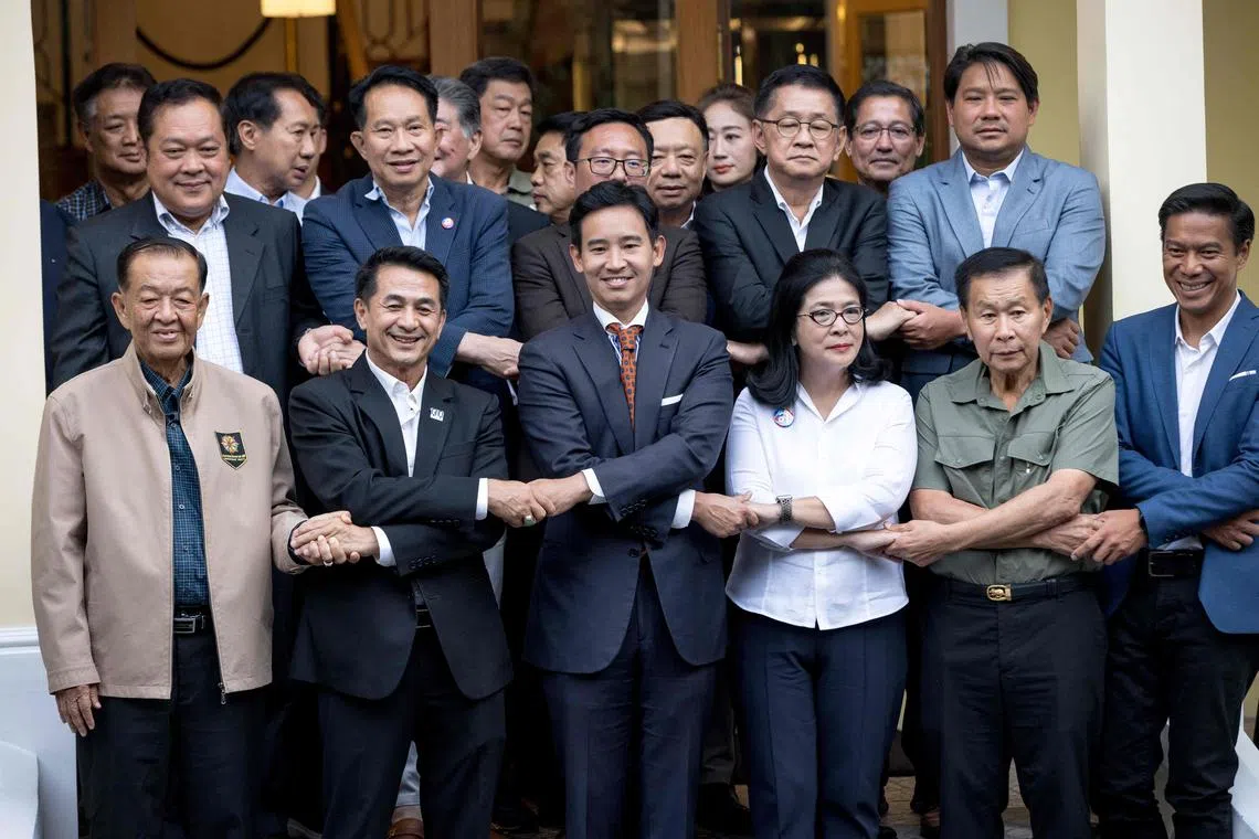 Move Forward Party leader Pita Limjaroenrat (third from left) with potential coalition partners, including Pheu Thai Party leader Chonlanan Srikaew (second from left), in Bangkok in May.