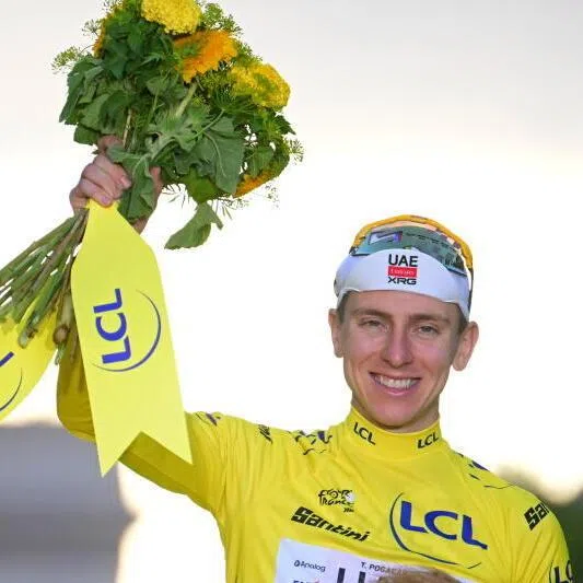UAE Team Emirates-XRG’s Tadej Pogacar celebrating on the podium in the yellow jersey after winning the Tour de France on July 26.