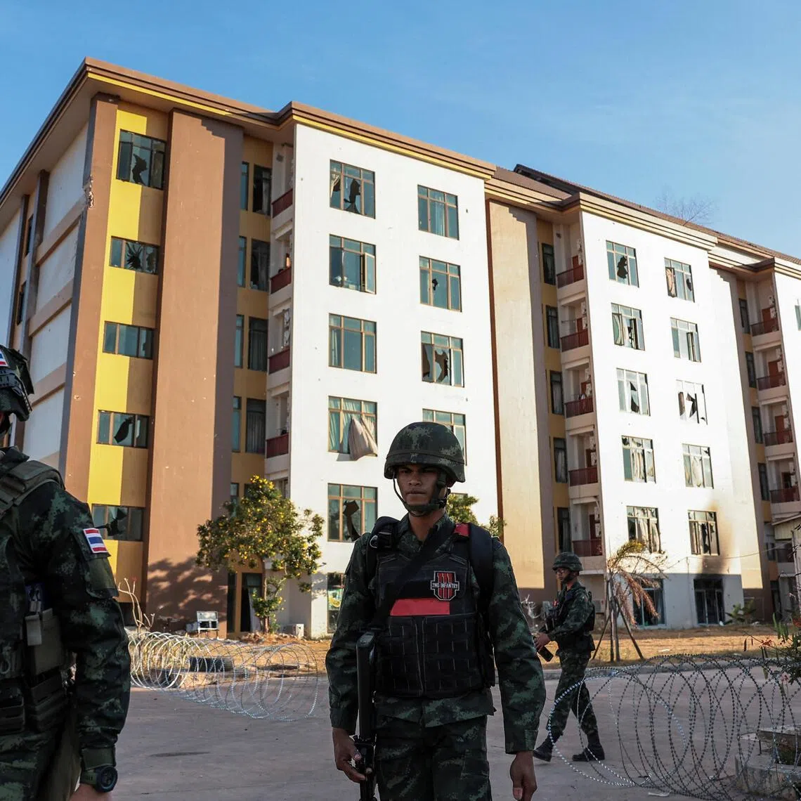 Thai soldiers walk near the O’Smach casino, a compound that was used for scam operations.
