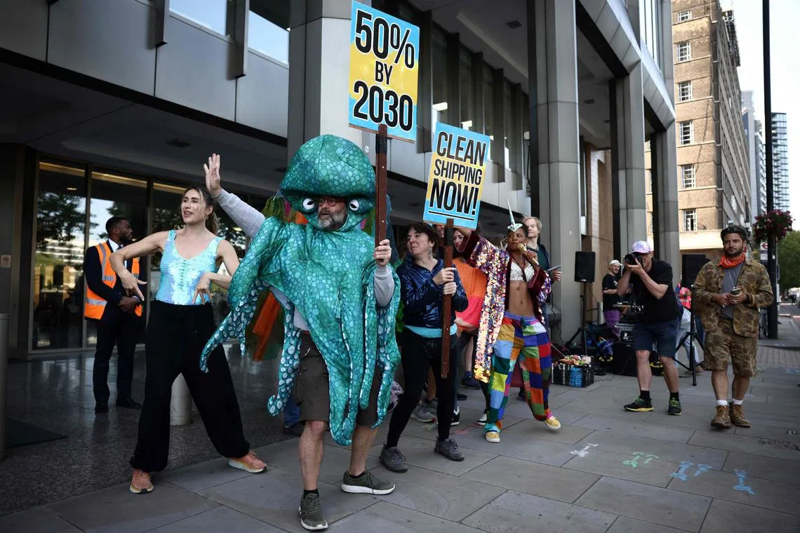 Activists holding placards as they take part in a morning rave outside the International Maritime Organisation (IMO) at the start of the 80th Marine Protection Committee (MEPC) conference in London on July 3. 