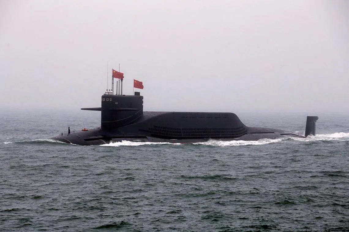 FILE PHOTO: FILE PHOTO: Chinese Navy's nuclear-powered submarine Long March 11 takes part in a naval parade off the eastern port city of Qingdao, to mark the 70th anniversary of the founding of Chinese People's Liberation Army Navy, China, April 23, 2019. REUTERS/Jason Lee/File Photo