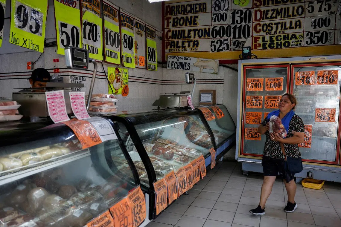 A woman carries a package of meat in a butcher's shop, in Monterrey, Mexico May 16, 2024. REUTERS/Daniel Becerril/File Photo